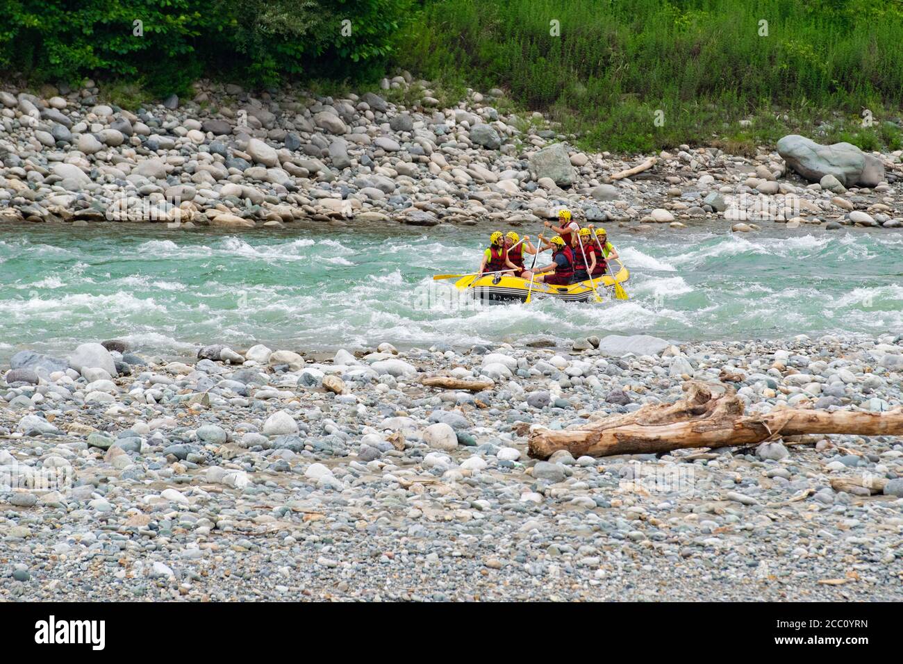 Rize, TURKEY - 2016: Rafting on a mountain river. Waves with spray and foam crashing on the side of the boat, and people rowing oars. Extrem sport. Stock Photo