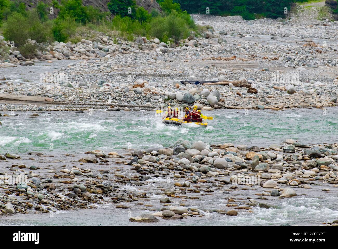 Rize, TURKEY - 2016: Rafting on a mountain river. Waves with spray and foam crashing on the side of the boat, and people rowing oars. Extrem sport. Stock Photo