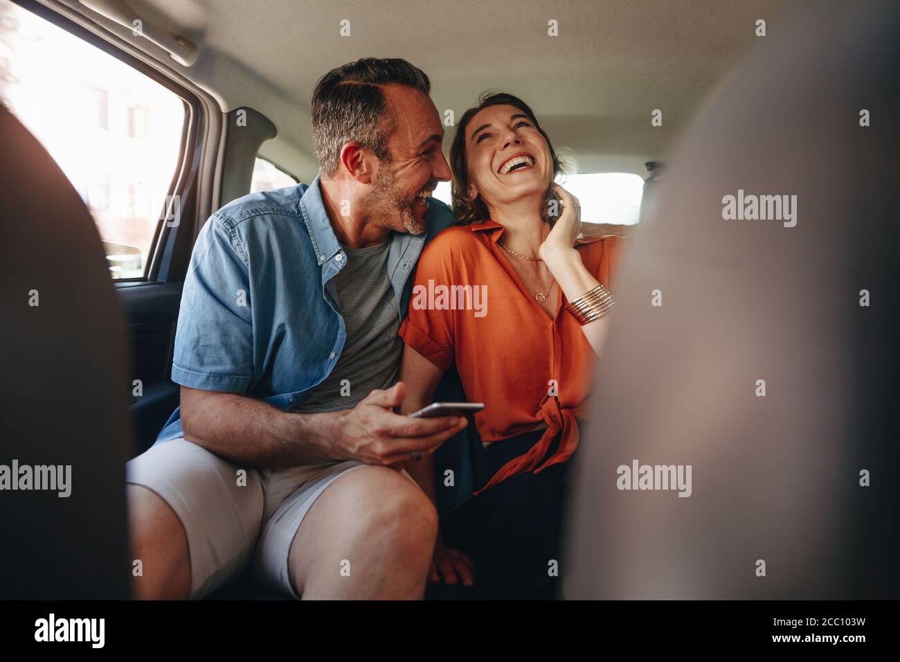 Happy Couple Having Fun In The Backseat Of A Car Man And Woman