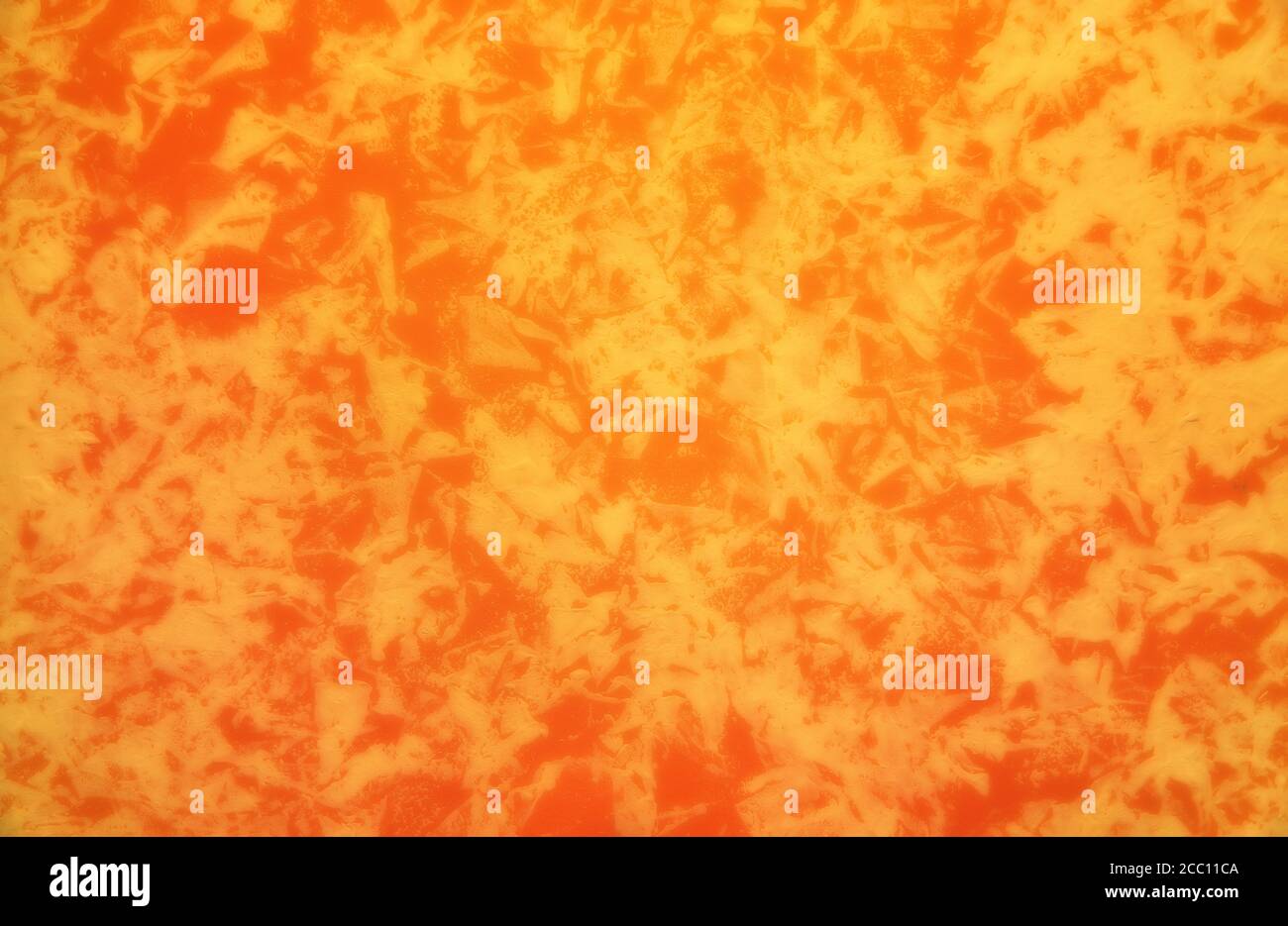 Orange colored patterned wallpaper background. Stock Photo