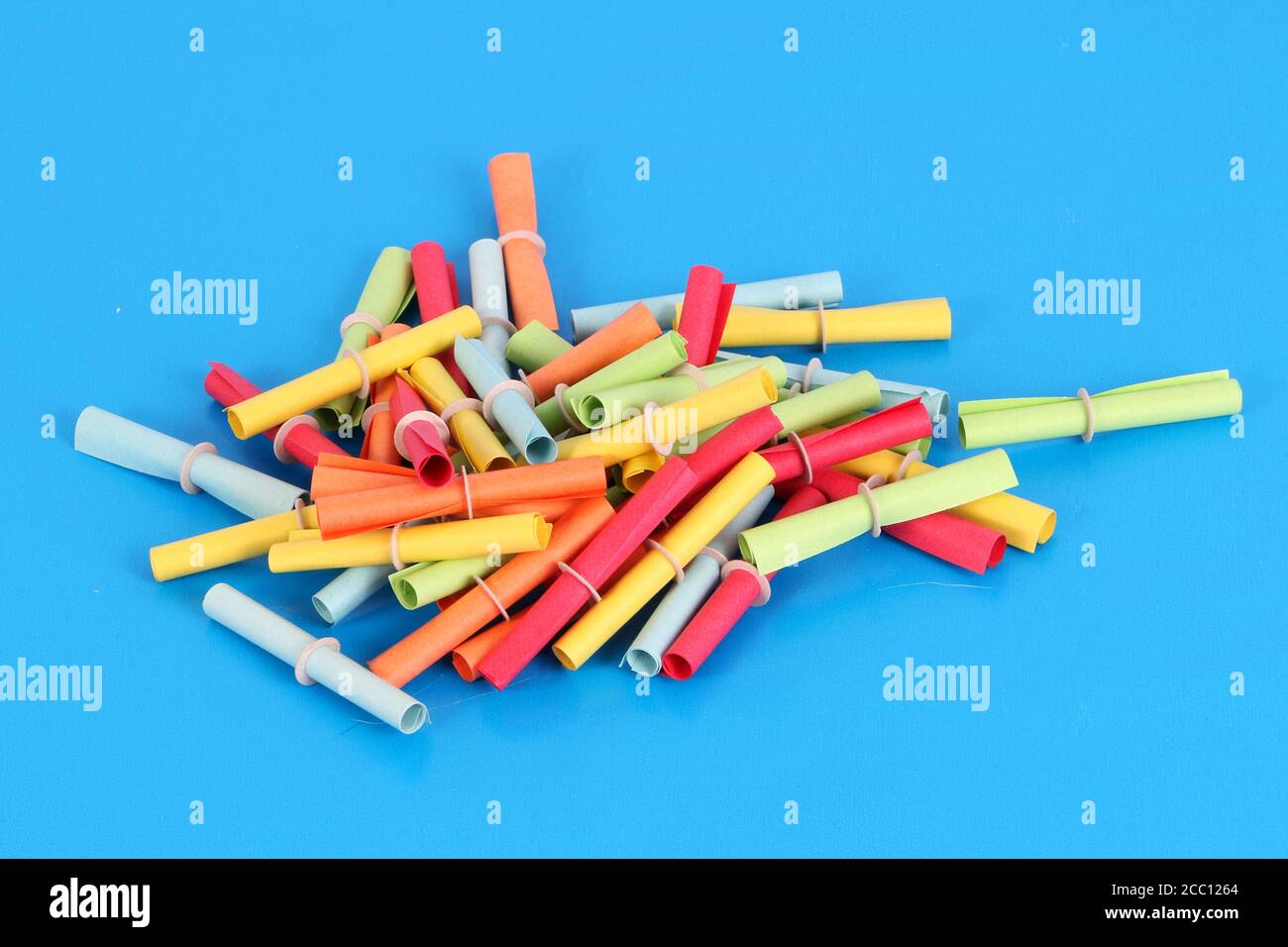 Closeup of a heap of colorful tombola tickets on a blue background Stock Photo