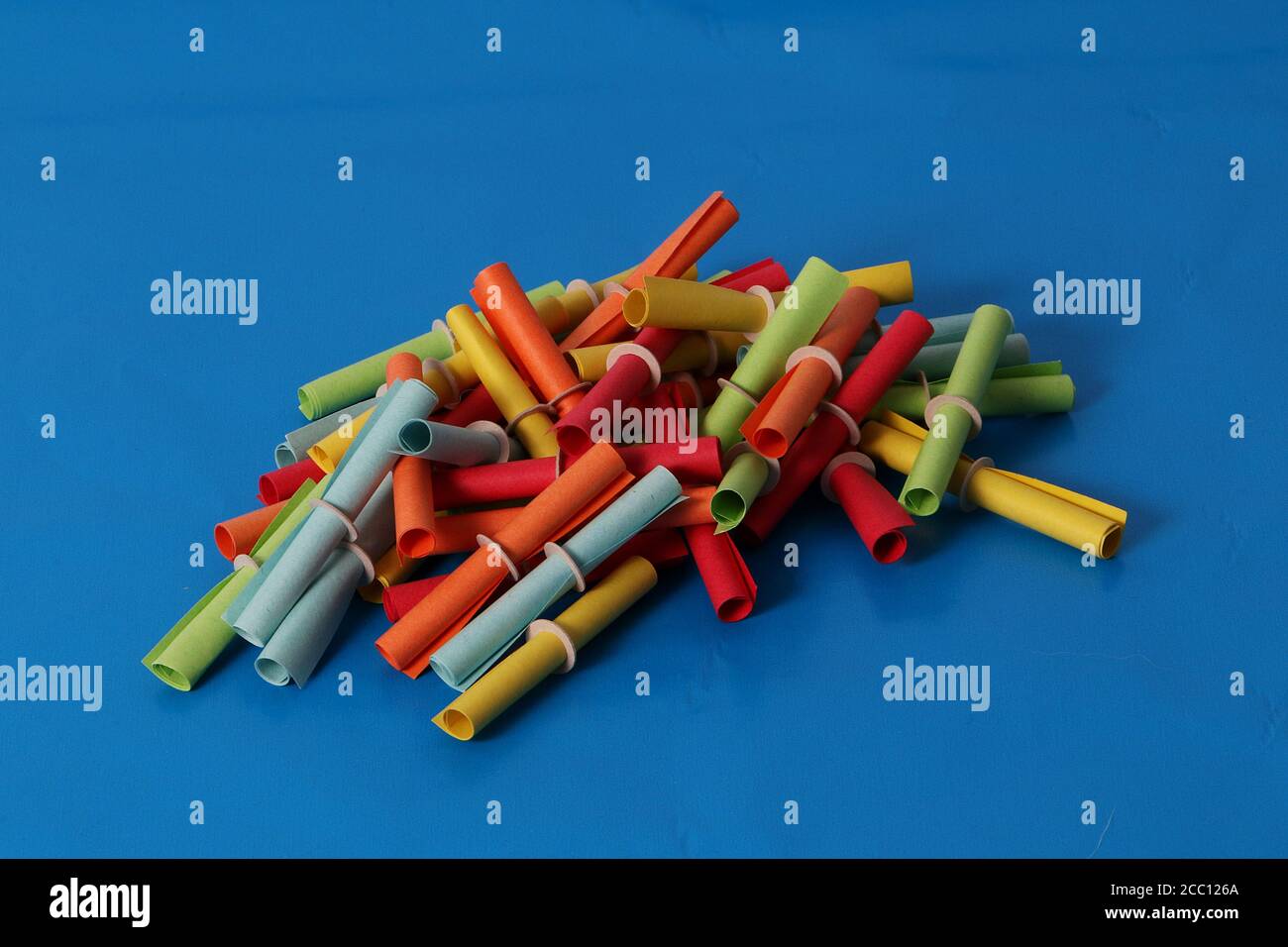 Closeup of a heap of colorful tombola tickets on a blue background Stock Photo