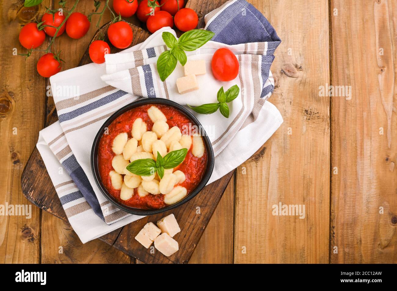 Homemade Italian Gnocchi with Red Sauce, Cheese with basil, olive oil . Close up. Home cooking. Traditional Italian cuisine from Rome and Sardinia. Above Stock Photo