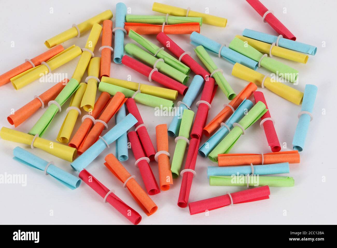 Closeup of a heap of colorful tombola tickets on a white background Stock Photo
