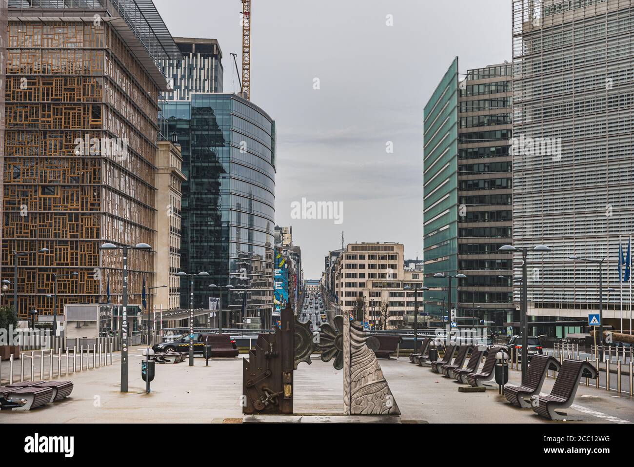 Growing businesses and modern buildings by Le Berlaymont (European Commission) with a flower like gear statue represent a synthetic, fake society Stock Photo