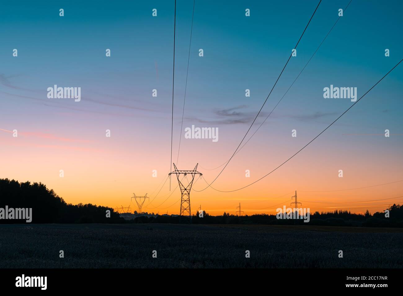 Electricity overhead power lines on a field in a countryside during ...