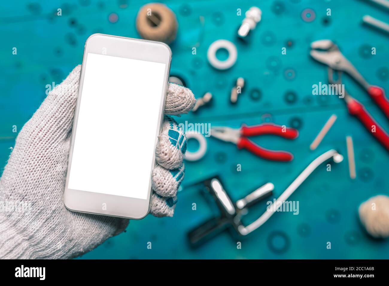 Plumbing app for mobile phones mock up, plumber holding smartphone with blank screen Stock Photo