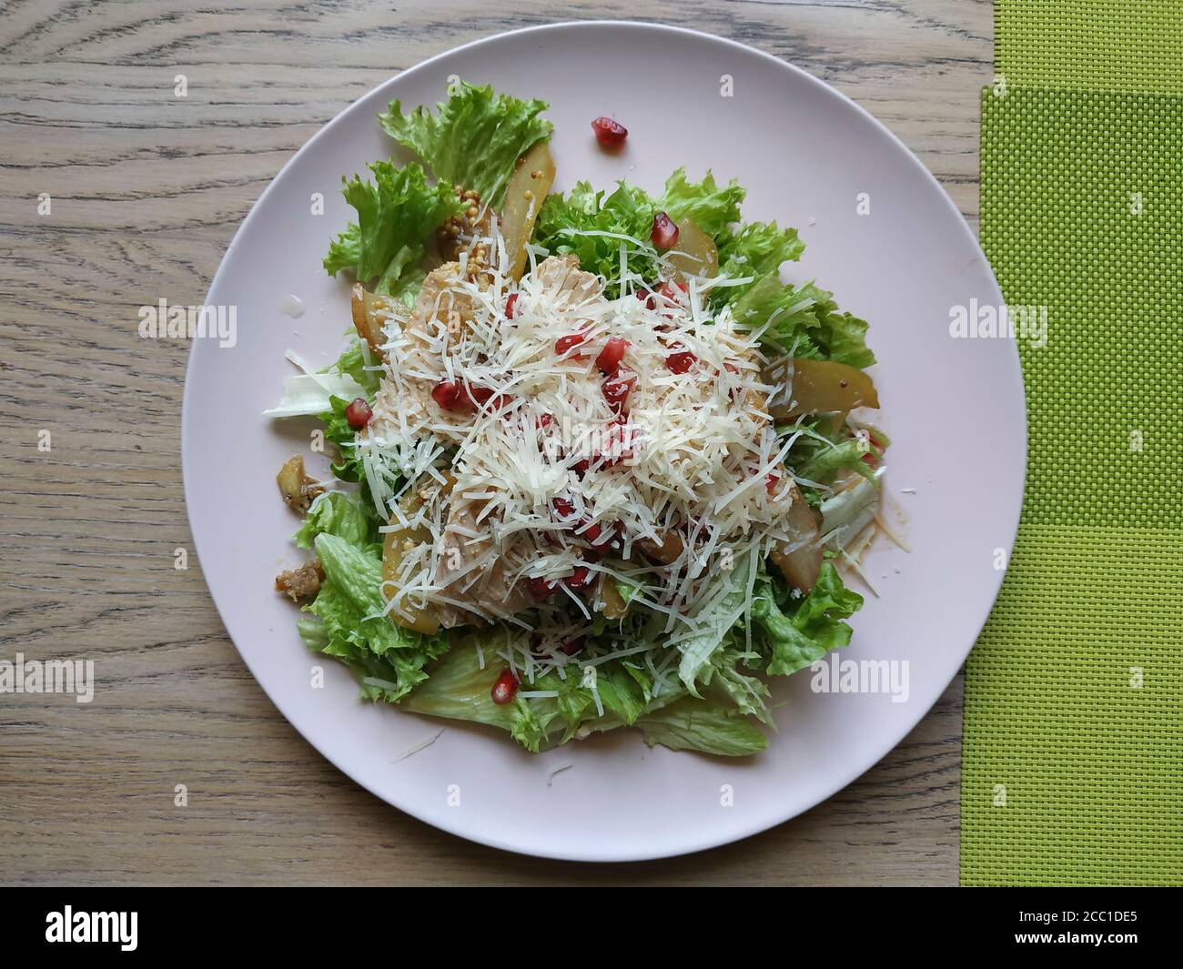 https://c8.alamy.com/comp/2CC1DE5/nice-salad-salad-mix-with-turkey-fillet-with-pear-and-pomegranate-seeds-sprinkled-with-parmesan-cheese-2CC1DE5.jpg