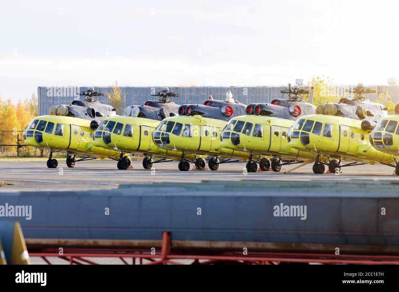 Several helicopters parked at the airport for repairs maintenance Stock Photo