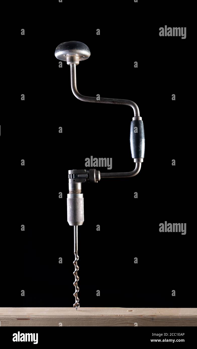 Old Fashioned Brace Hand Drill on a Black background with side lighting