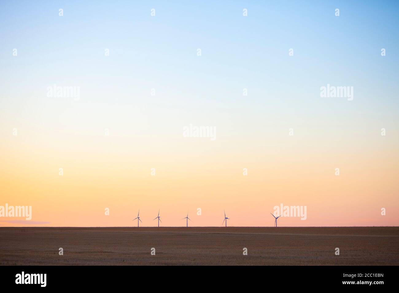 wind turbines behind empty fields in the north of france during sunset ...
