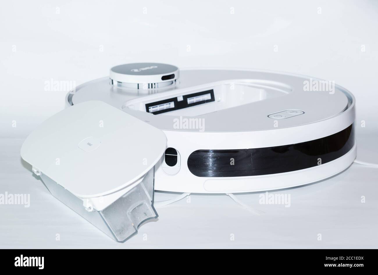 Robot Vacuum Cleaner In Front Of White Background Dust Container