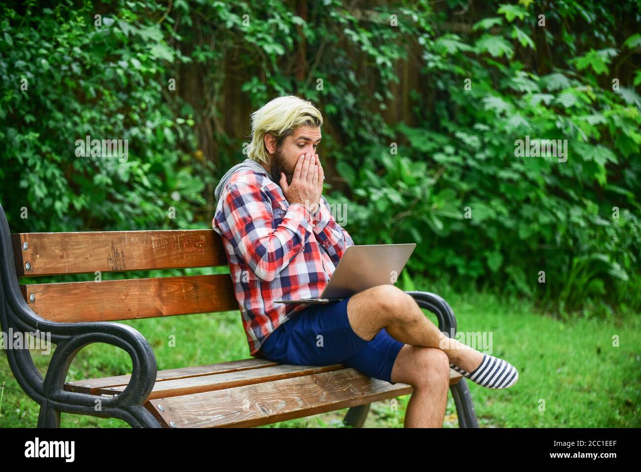 Fresh air. Mobile internet. Working online. Hipster inspired work in park. Modern laptop. Remote job. Online shopping. Agile business. Bearded guy sit bench park nature background. Work and relax. Stock Photo