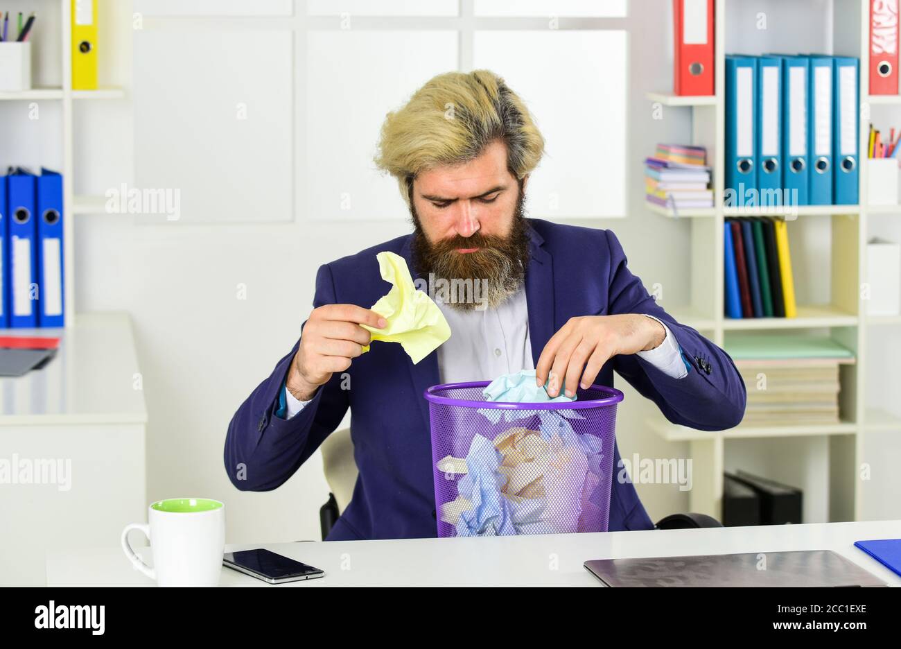 Rummaging through the trash. office worker dig in garbage bin