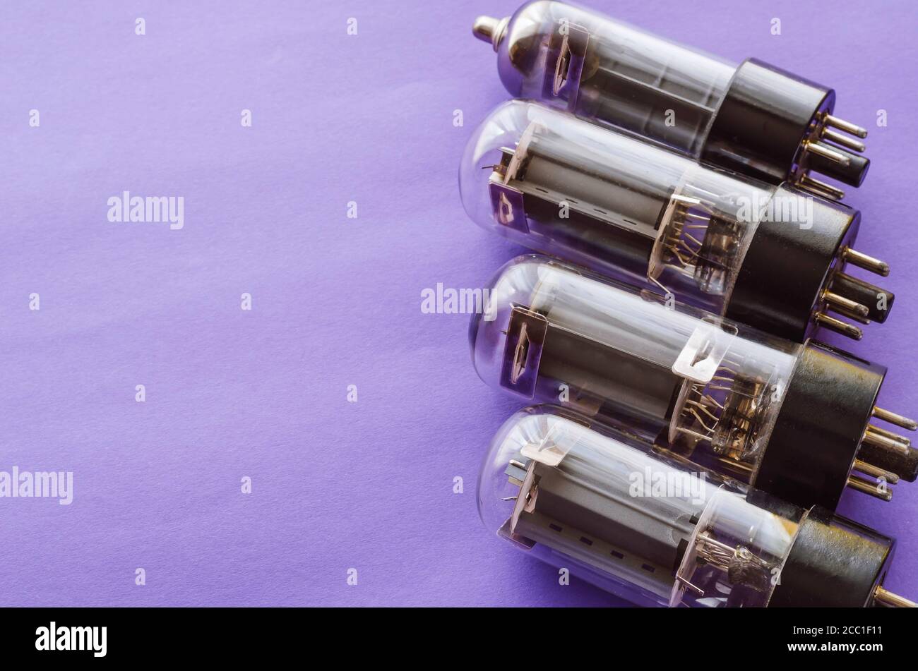 Four vacuum tubes on a blue background. Outdated radio tubes. Vintage radio  parts. Selective focus Stock Photo - Alamy
