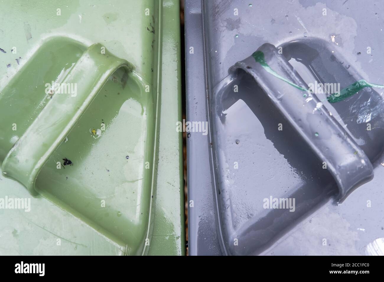 Top down view of a household waste bins used by a typical household. Seen after a heavy downpour. Stock Photo