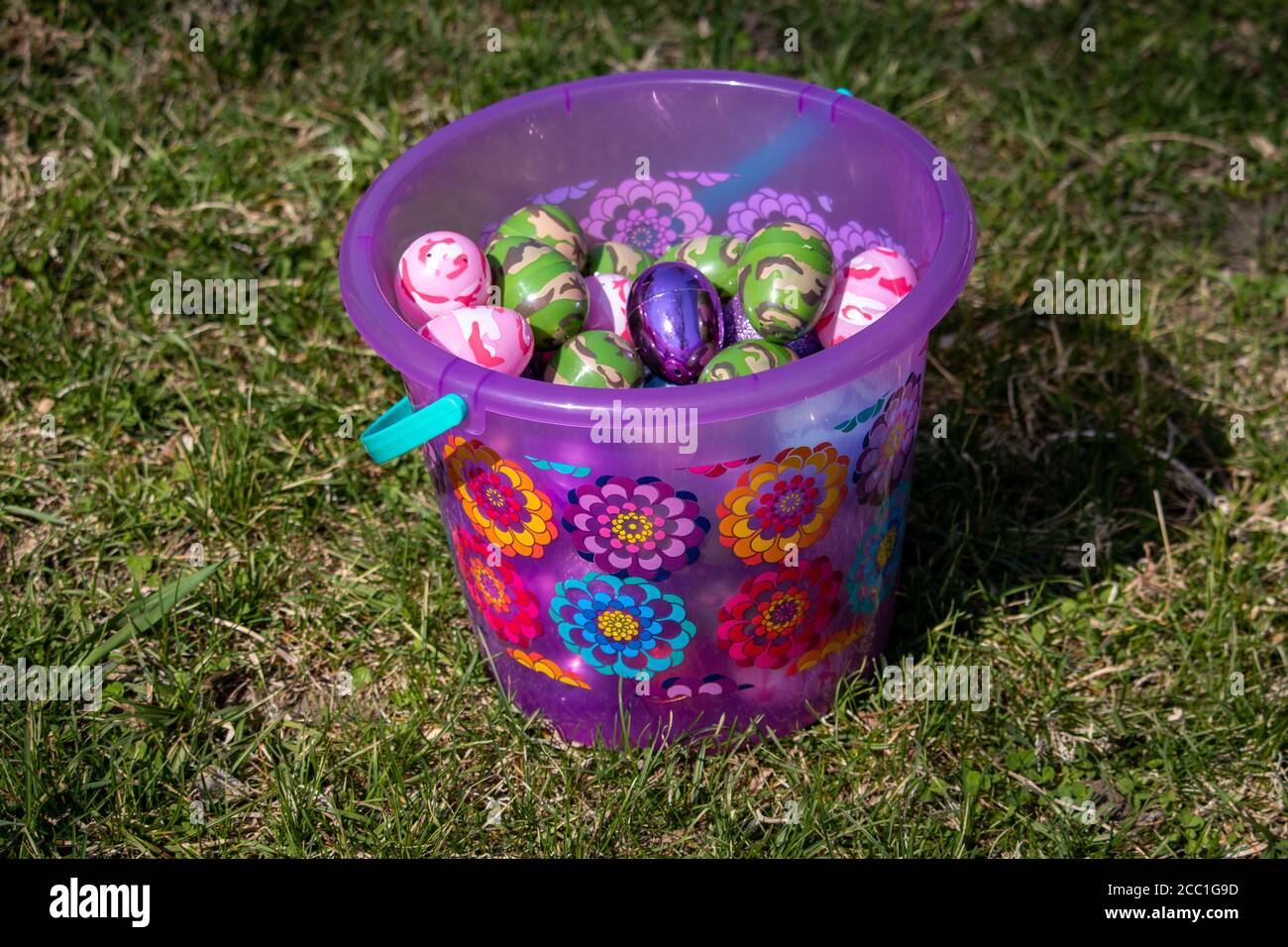 Easter basket with Bright pink and flowers full of Easter egg hidden in green grass . High quality photo Stock Photo