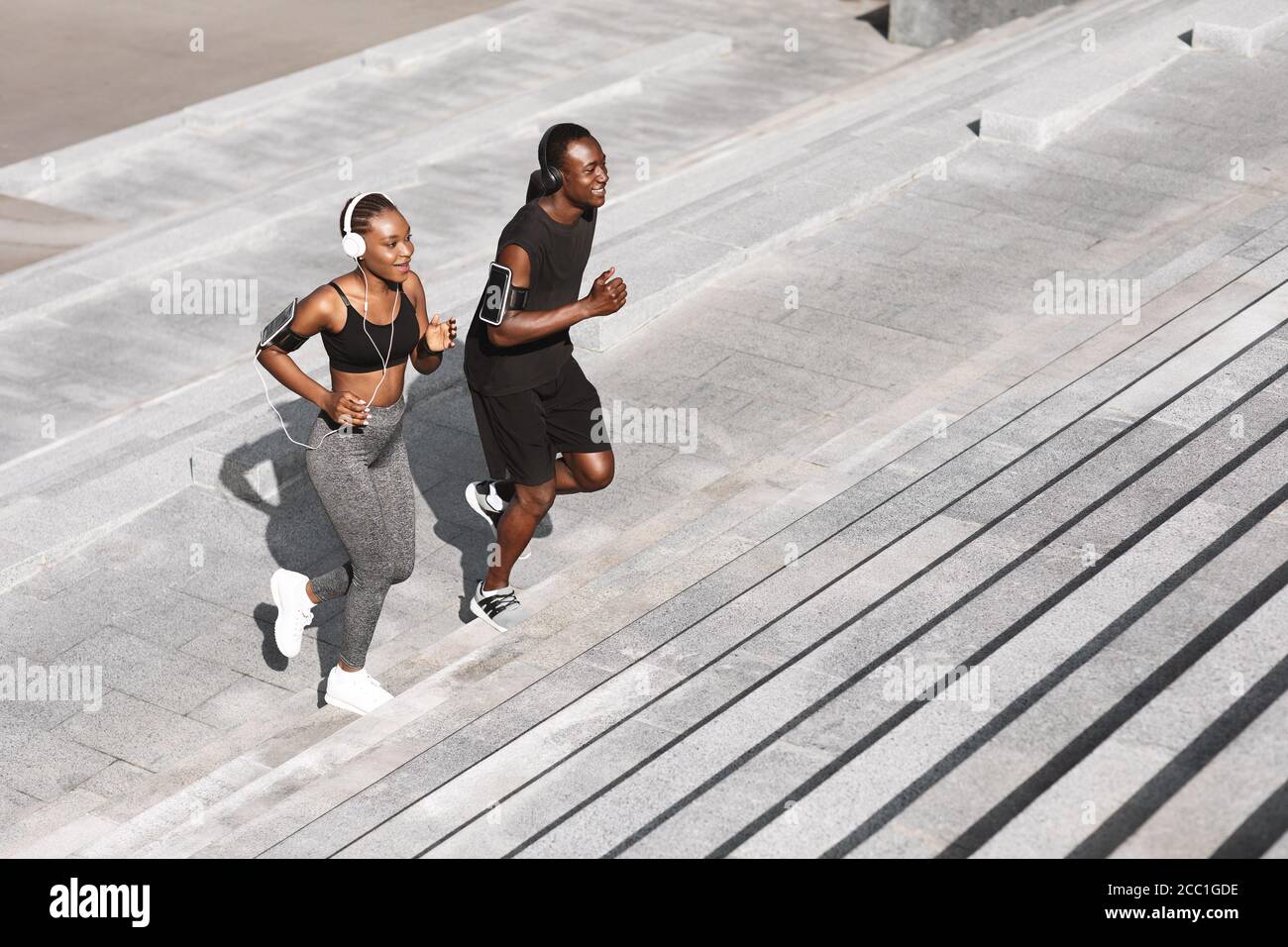 Black man running up stairs hi-res stock photography and images - Alamy