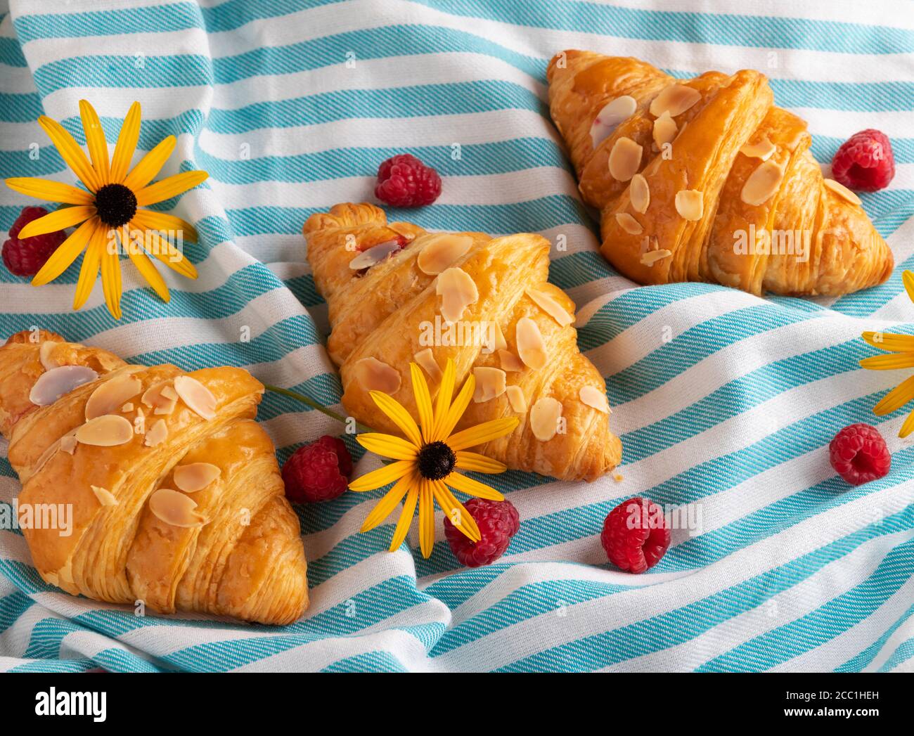 Yummy freshly three croissants with raspberries, view from above Stock Photo