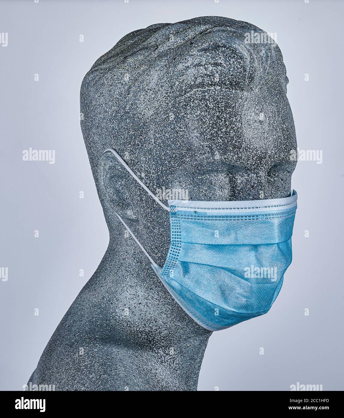 Male display dummy, wearing a protective medical face mask, on grey background Stock Photo