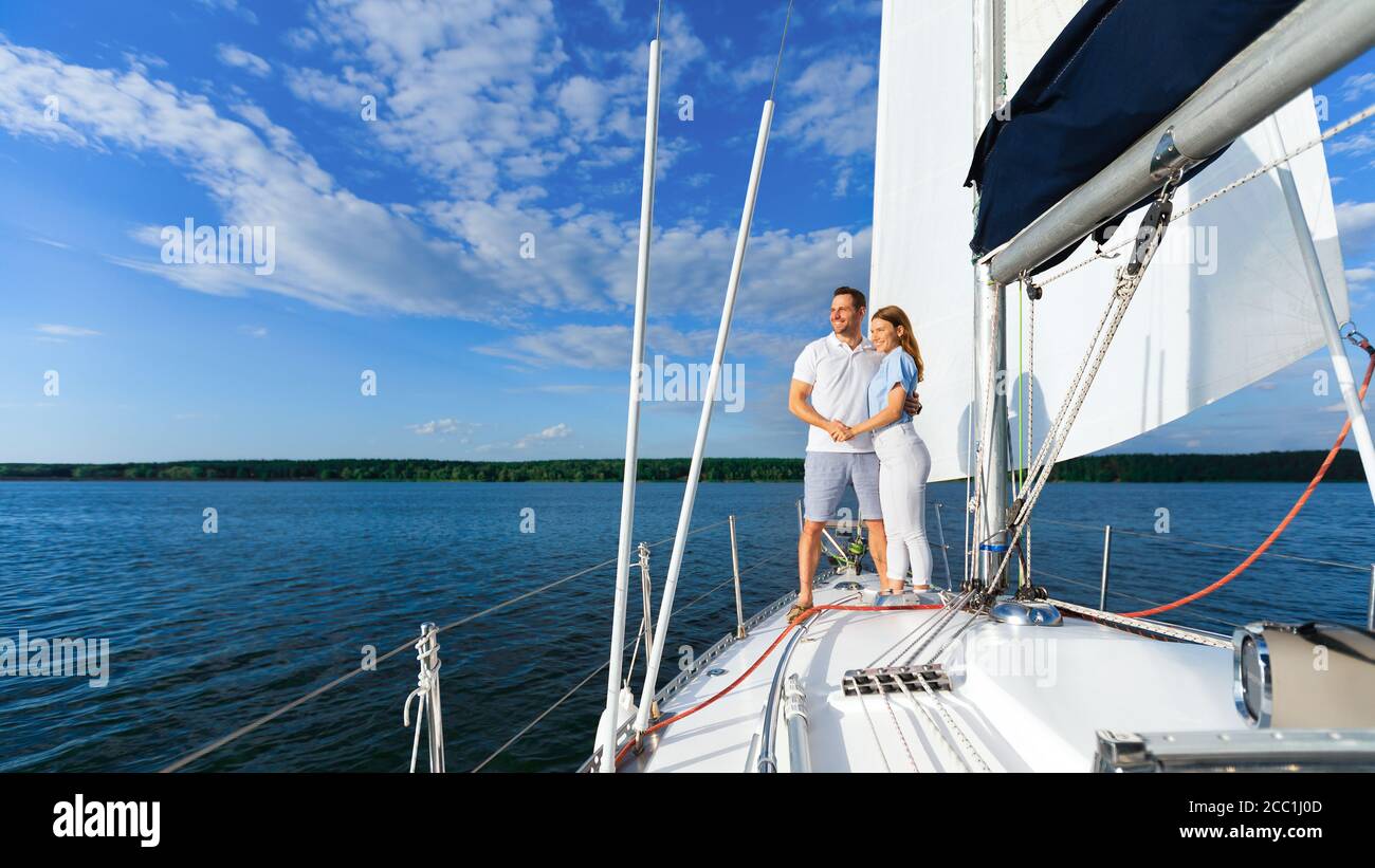 Loving Couple Standing On Yacht Enjoying Romantic Sailboat Tour, Panorama Stock Photo
