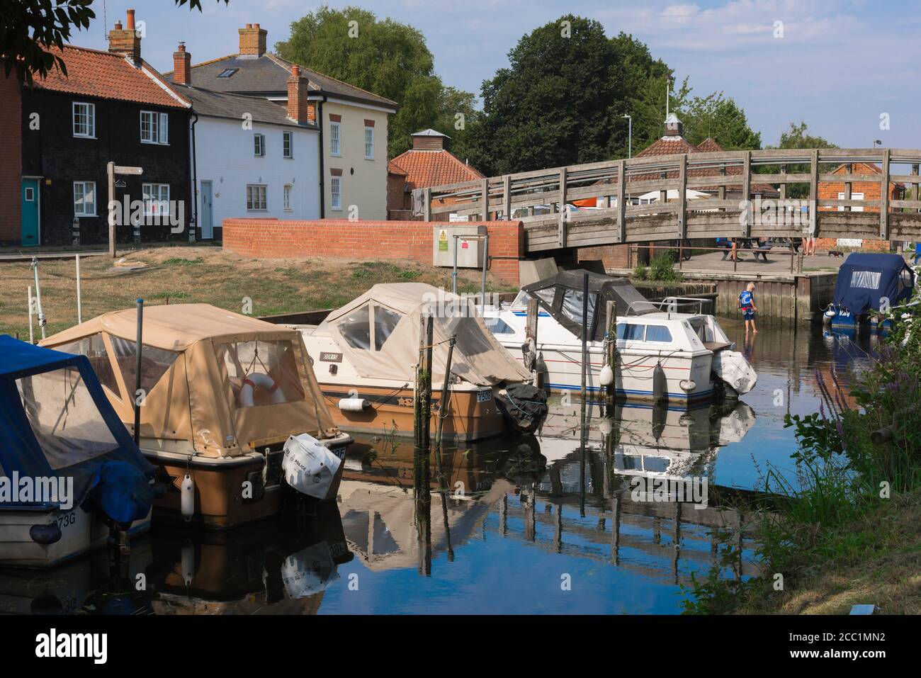 Suffolk UK, view in summer of a wooden bridge spanning an inlet of the River Waveney in Beccles, Suffolk, East Anglia, England, UK Stock Photo