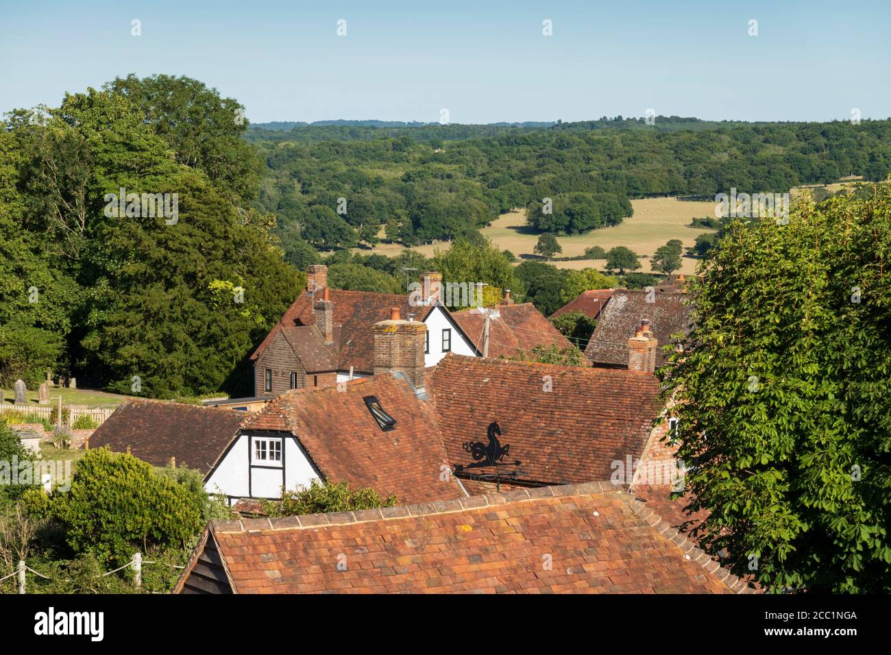 View over cottage rooftops and High Weald landscape in summer, Burwash, East Sussex, England, United Kingdom, Europe Stock Photo