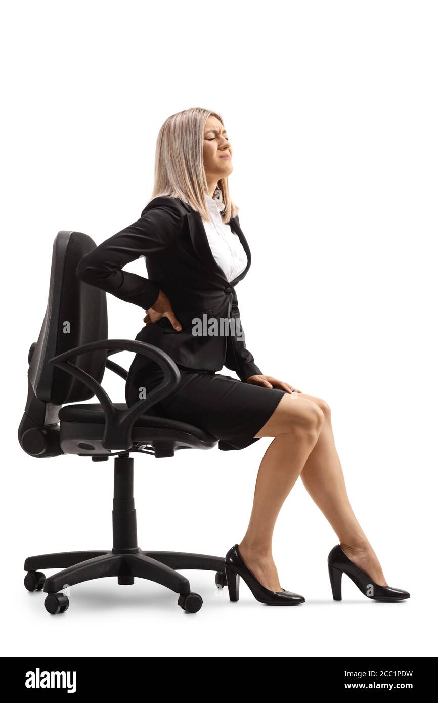 Young woman at work with a painful lower back sitting on a chair ...