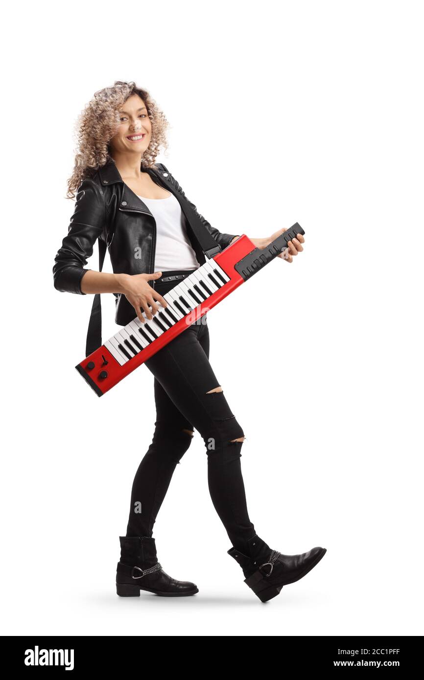 Full length portrait of a woman smiling and playing a keytar synthesizer isolated on white background Stock Photo