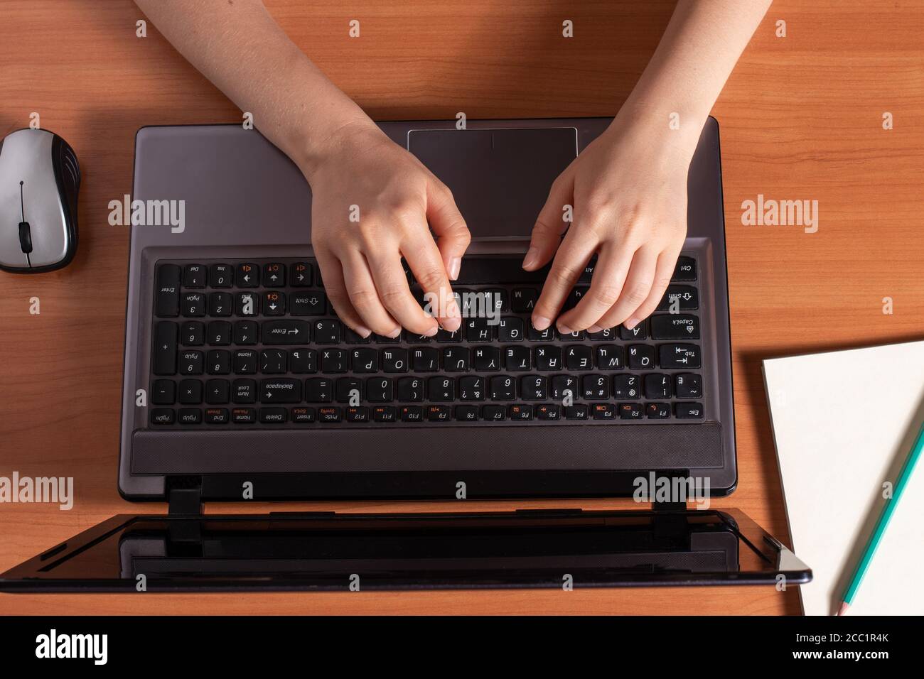 Human hands are typing text on a black laptop keyboard Stock Photo - Alamy