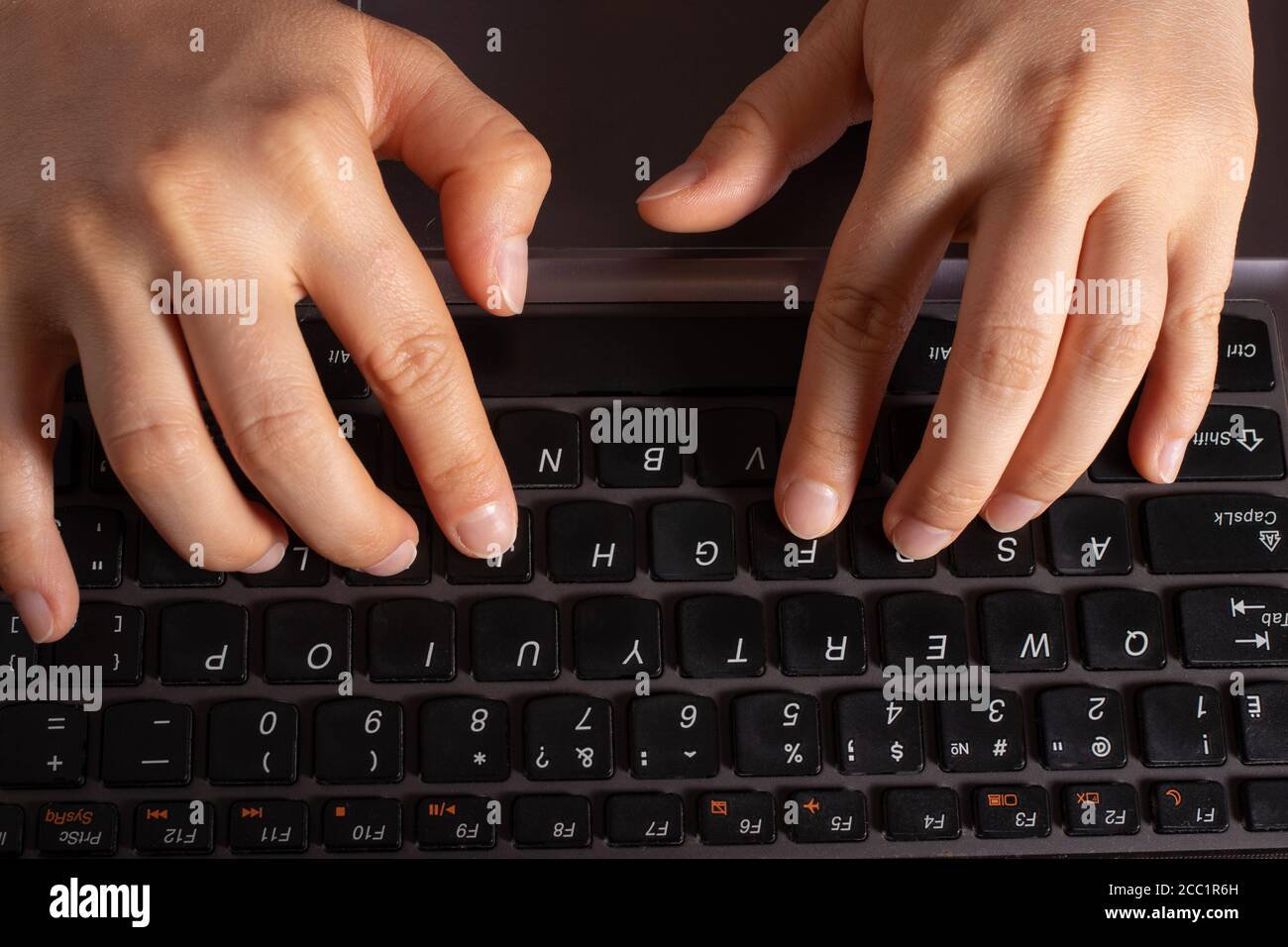 Human hands are typing text on a black laptop keyboard Stock Photo - Alamy