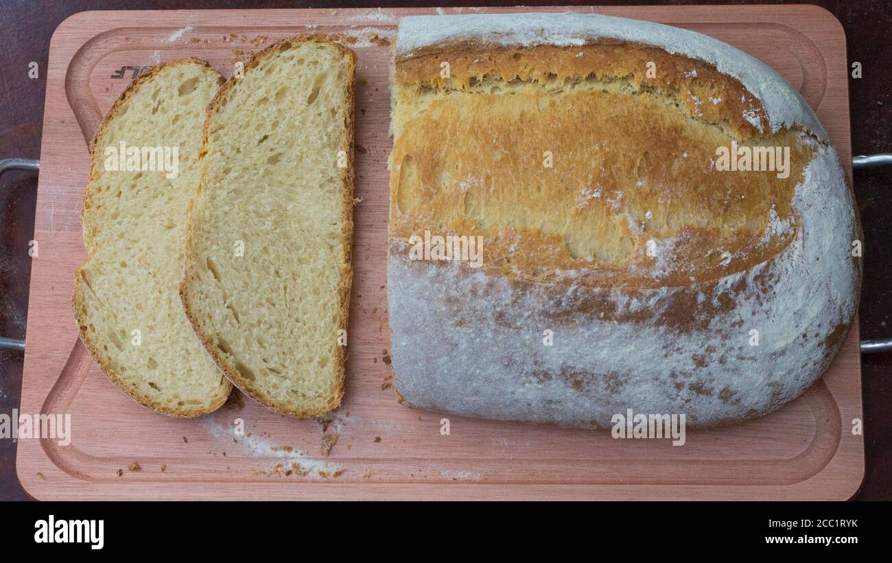 Artisan corn, milkd and butter Pain Au Levain bread, in a rustic setting. Stock Photo