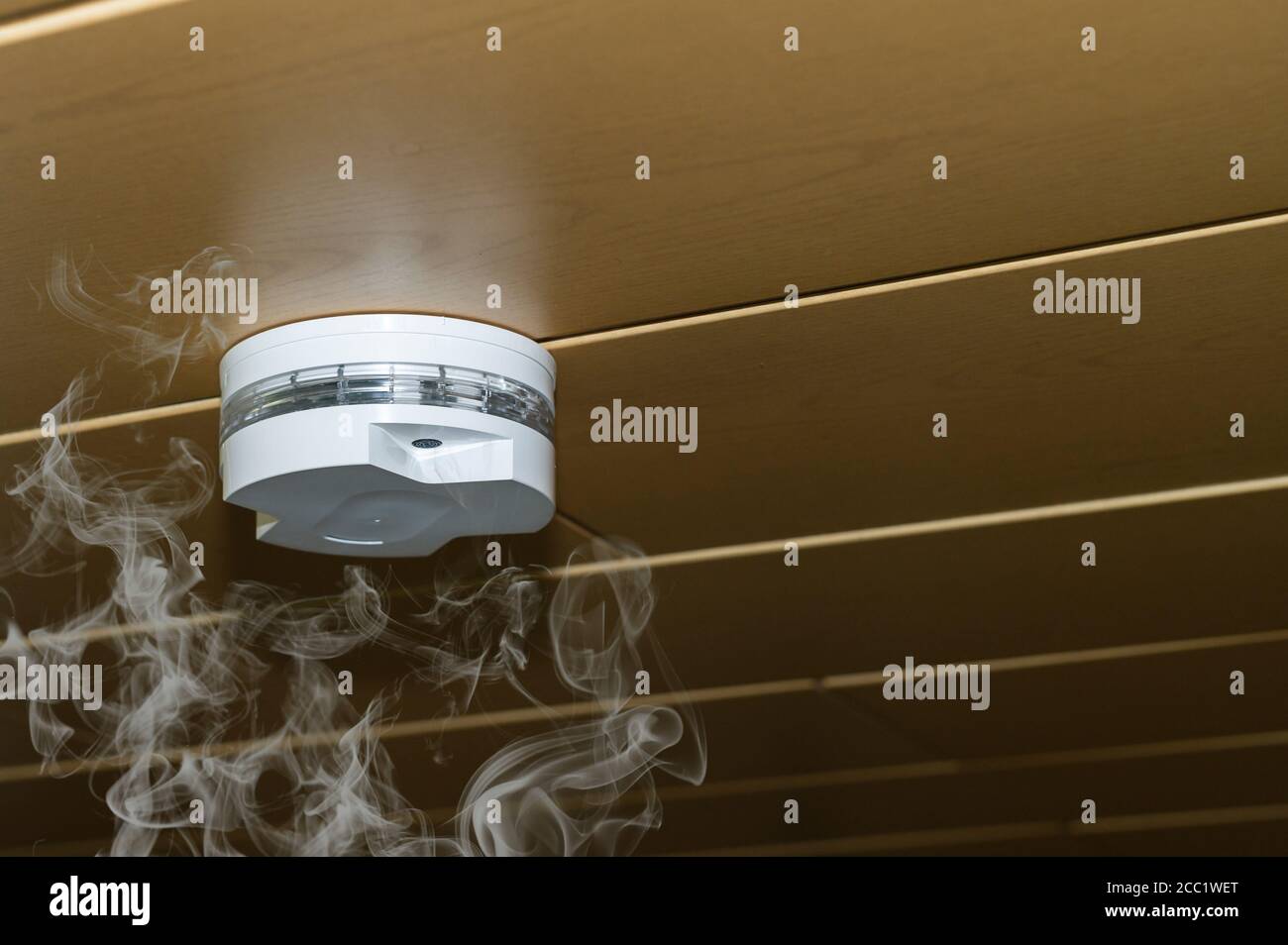Smoke rises to the smoke detector Stock Photo