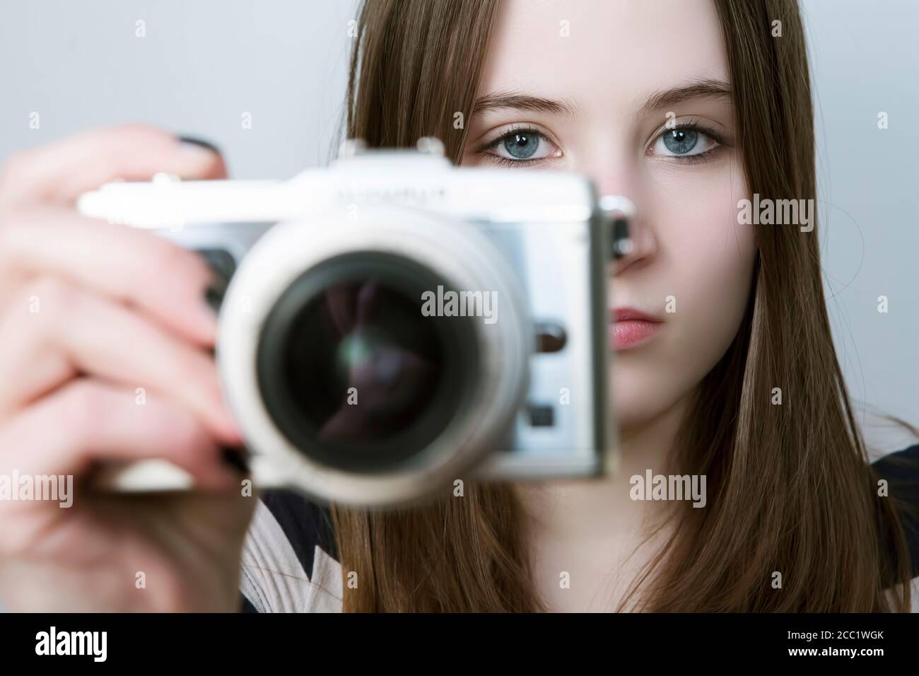 Portrait of Teenage girl holding digital camera Stock Photo
