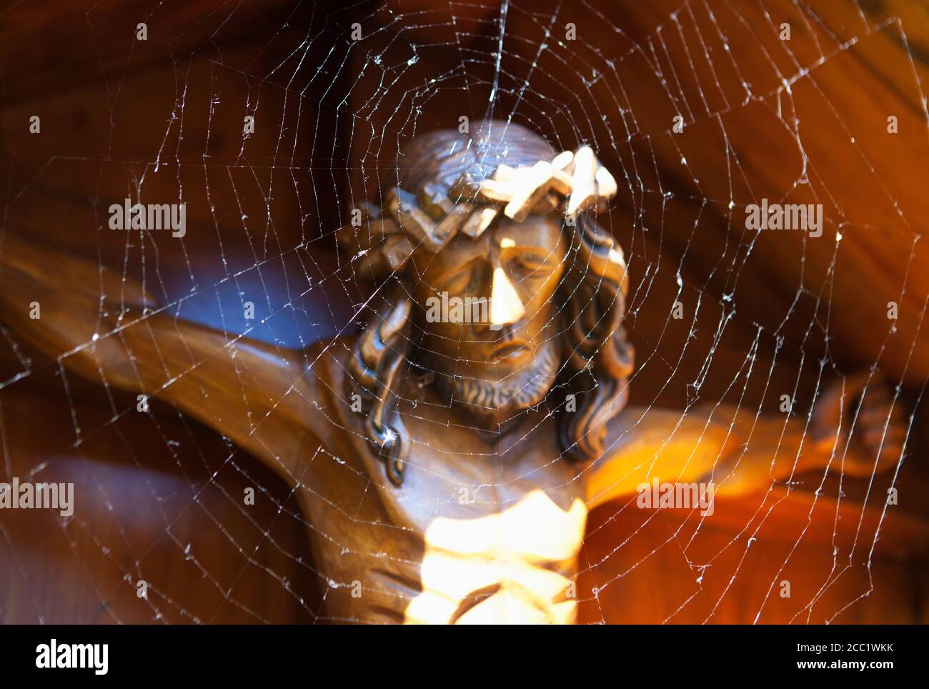 Austria, Spider web infront of crucifixion Stock Photo