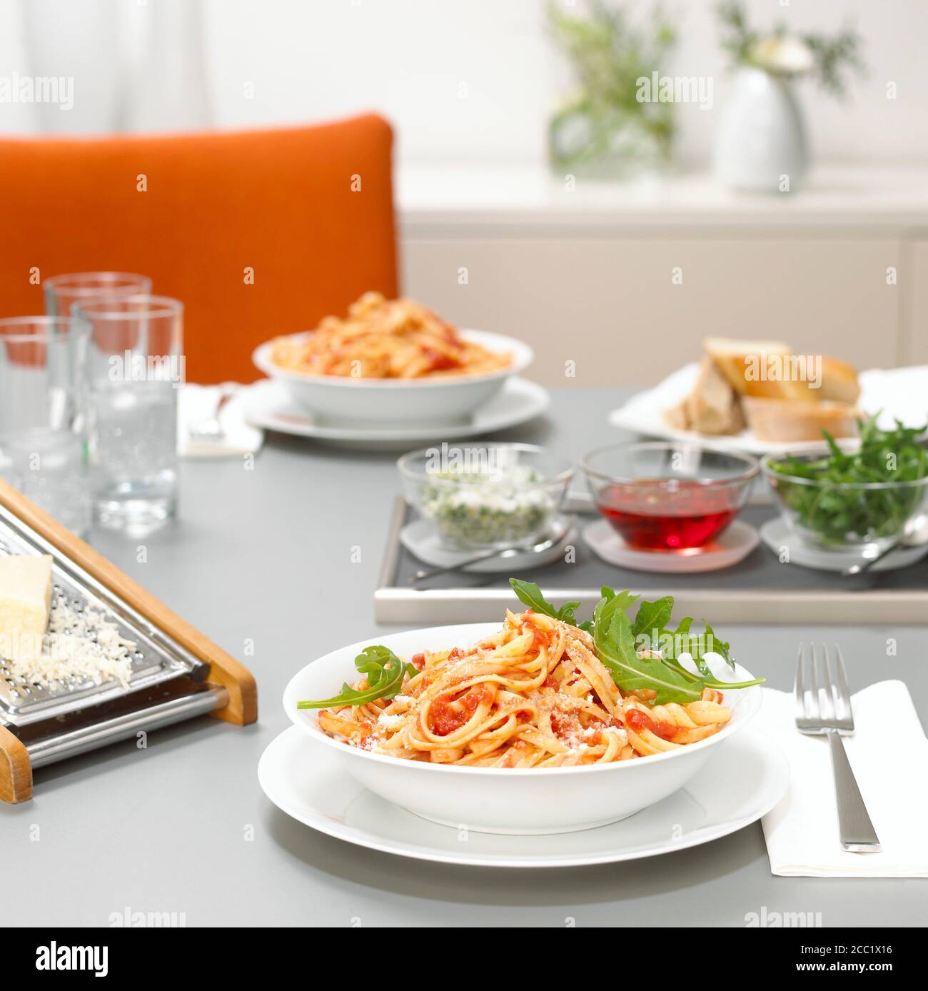Lunch for two, pasta with tomato sauce and rocket Stock Photo