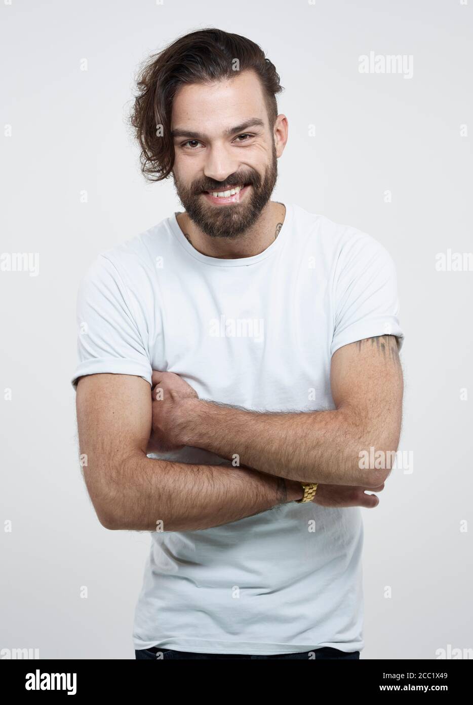 Portrait of young man against white background, smiling Stock Photo - Alamy