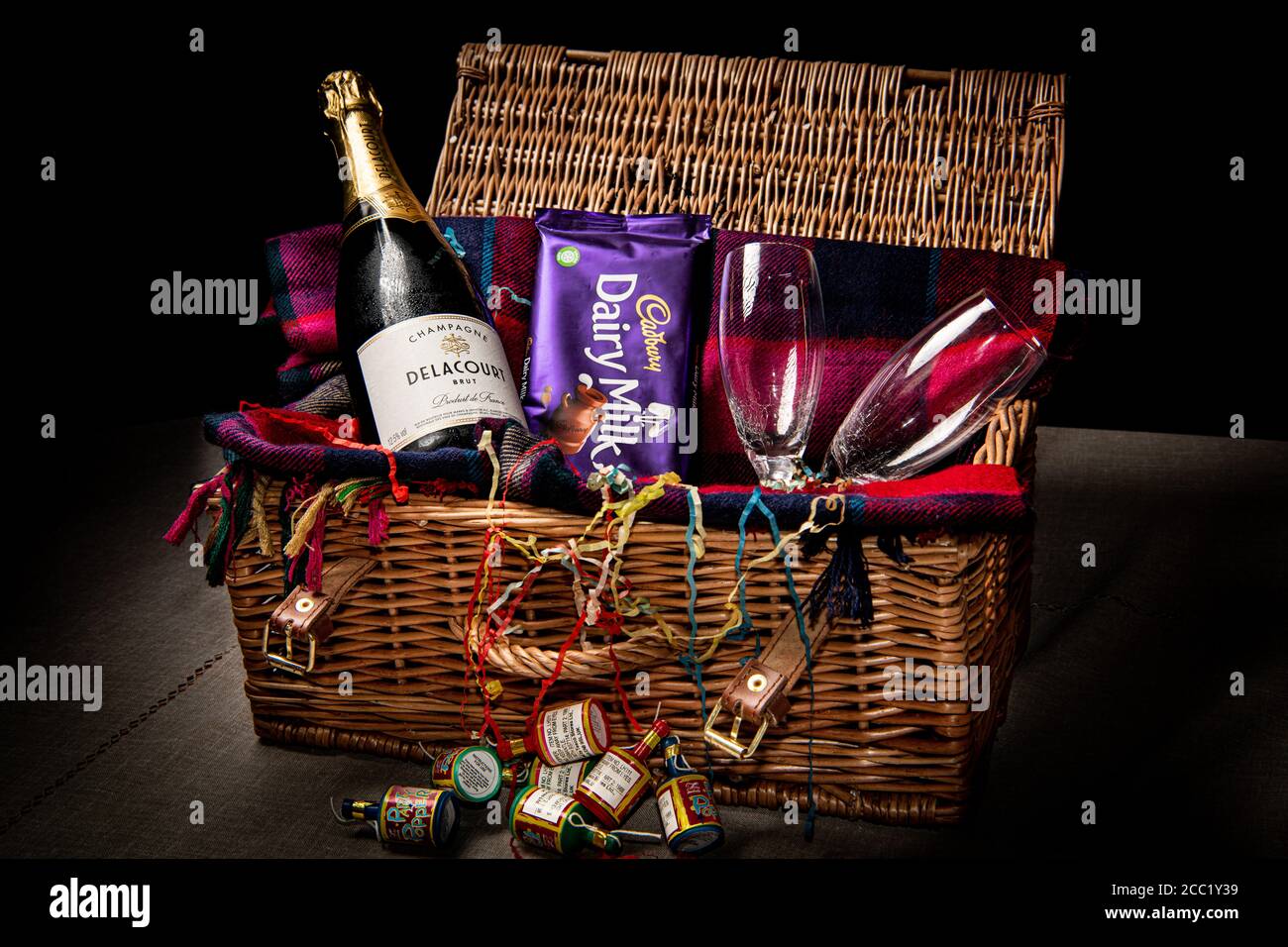 Champagne and glasses with chocolate in a basket party hamper Stock Photo