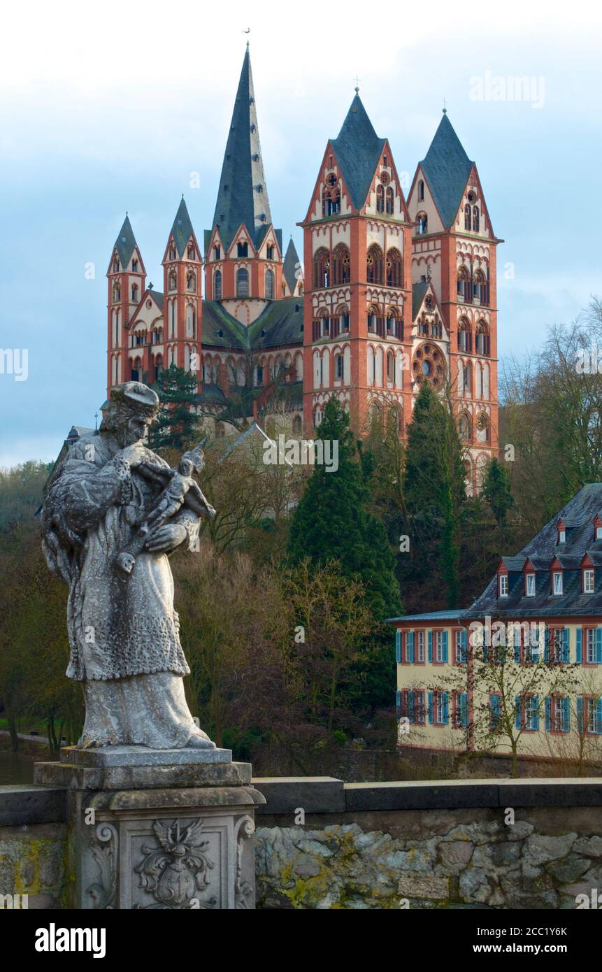 Germany, Hesse, View of Limburg cathedral with statue in front Stock Photo