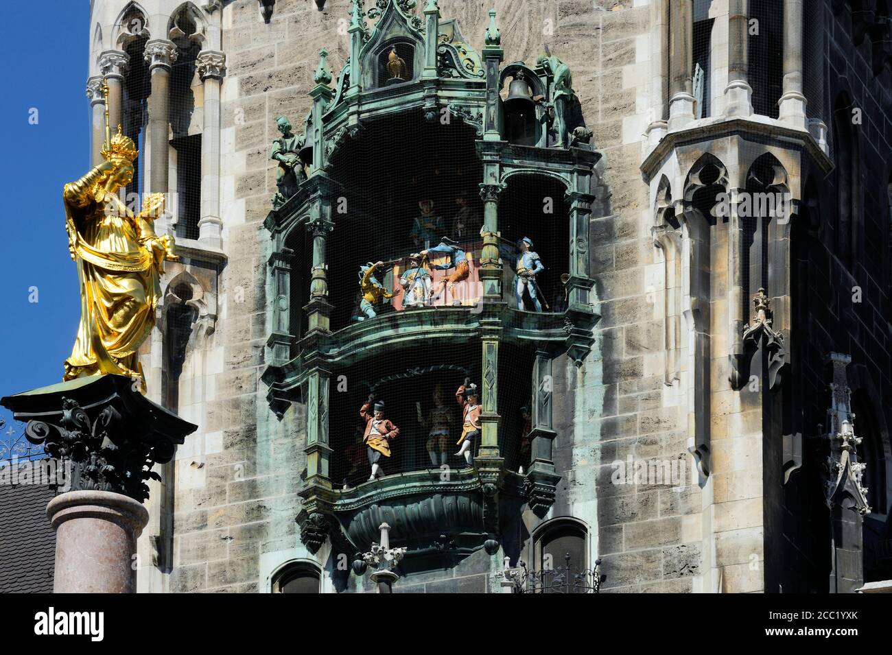 Germany, Bavaria, Munich, Statue of virgin mary and Glockenspiel Clock Stock Photo