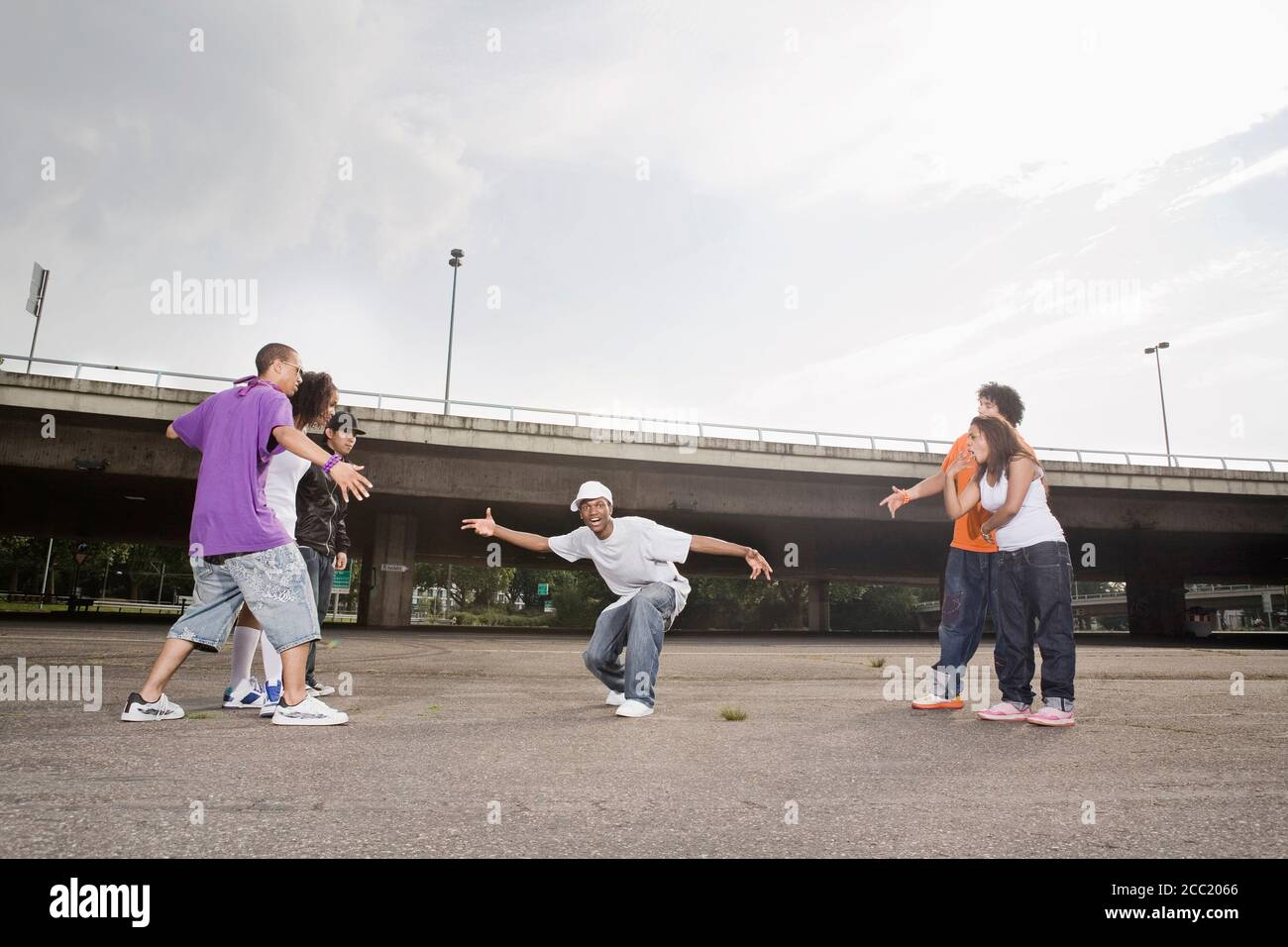 Germany, Cologne, Group of young people breakdancing on street Stock Photo