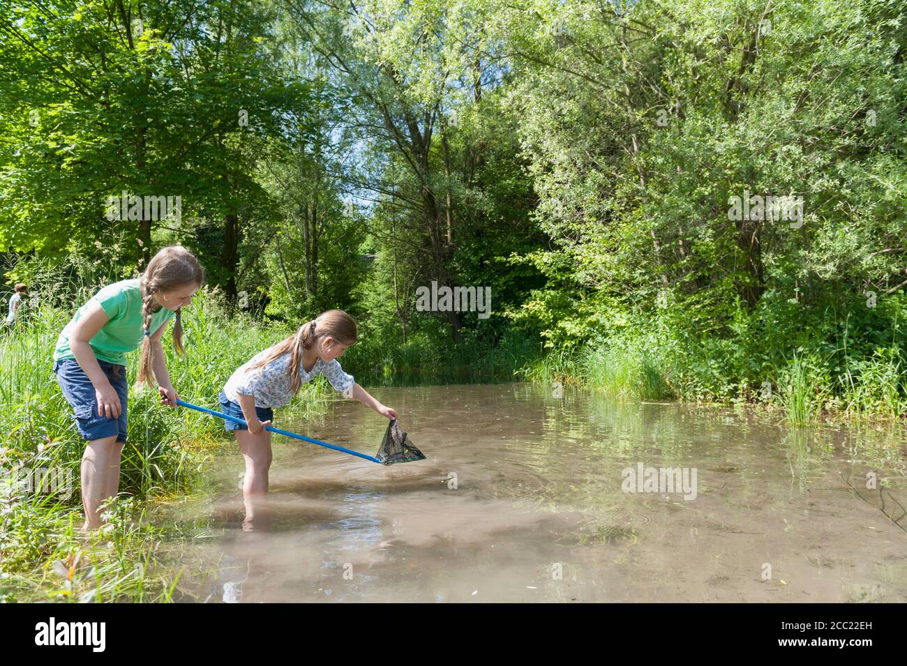 Girls with fishing net in lake hi-res stock photography and images
