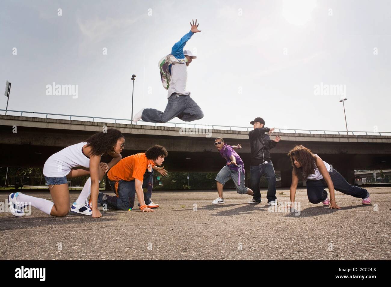 Germany, Cologne, Group of young people dancing on street Stock Photo
