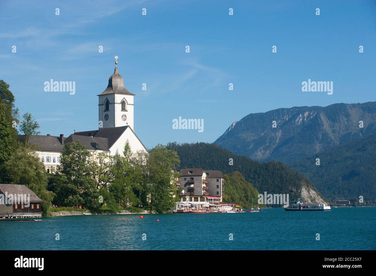 Austria, View of Pilgrimage church at St. Wolfgang, Wolfgangsee lake in foreground Stock Photo