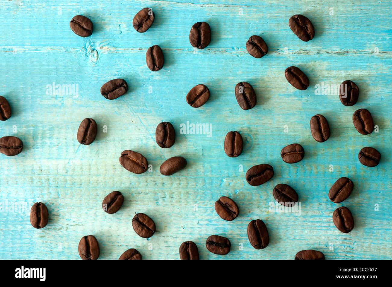 Coffee beans on wooden table, close up Stock Photo