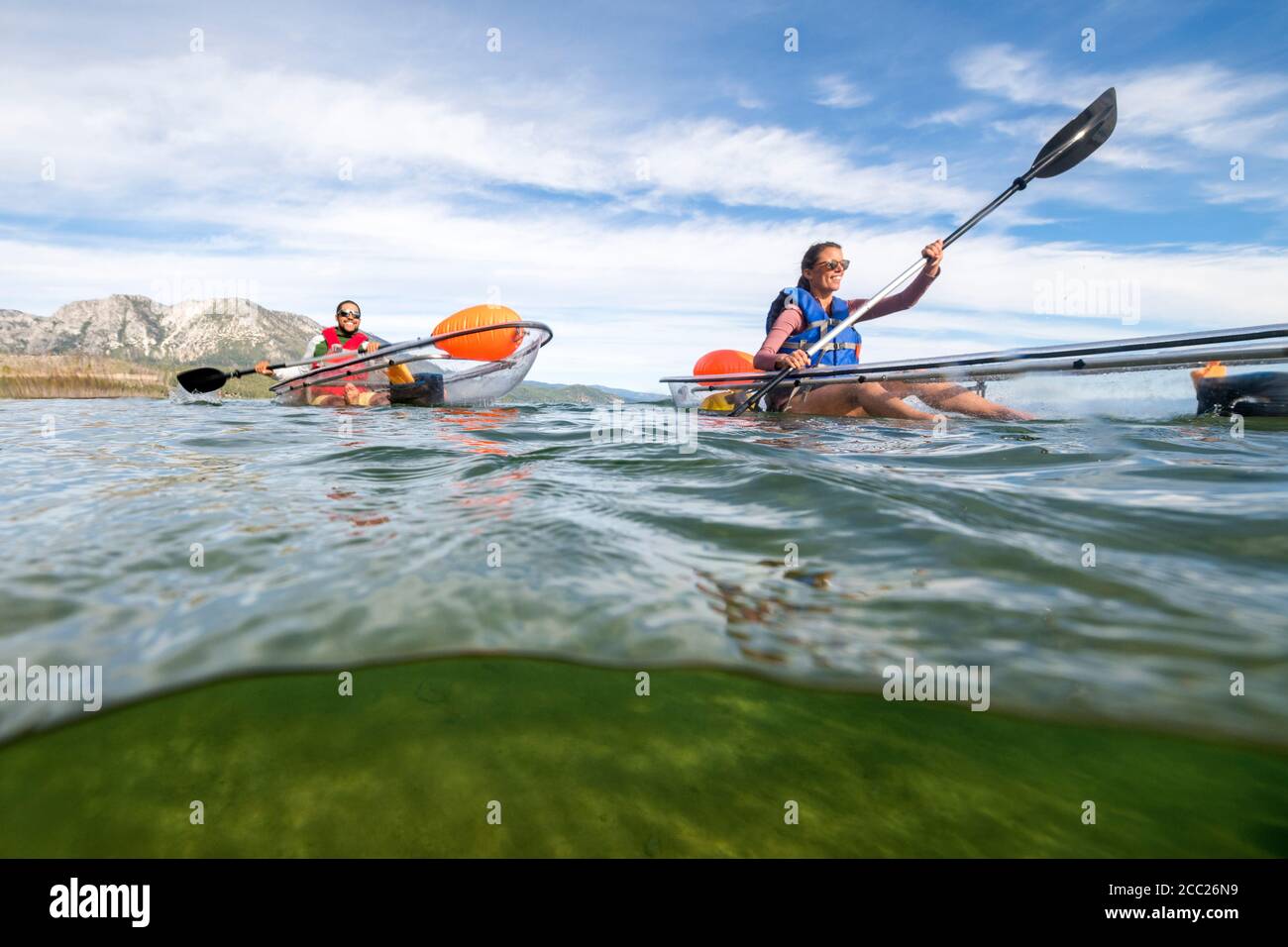 An over-under shot of two kayakers enjoying a summer morning in their transparent  kayaks exploring the clear waters of South Lake Tahoe, California Stock  Photo - Alamy