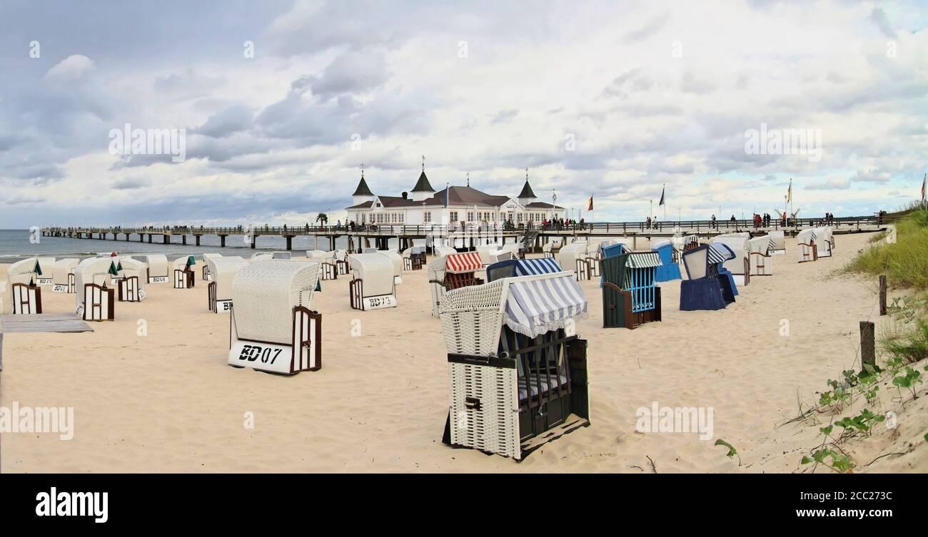 Germany, Usedom, Ahlbeck, View of hooded beach chairs by lake Stock Photo