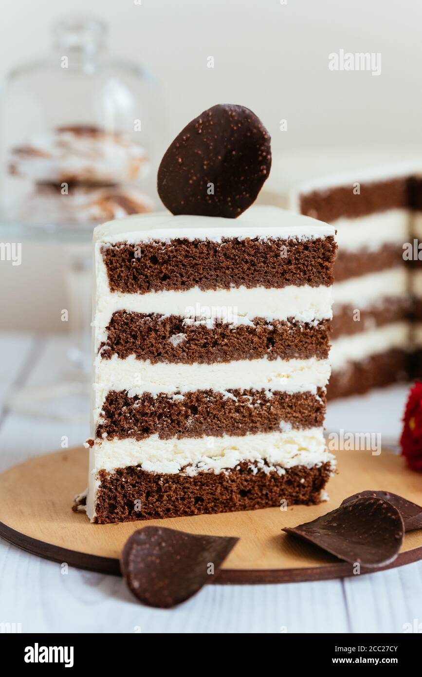 a piece of chocolate cake with white cream and a piece of chocolate ...