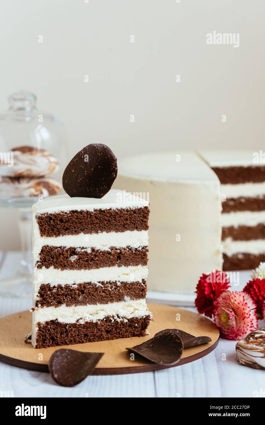 a piece of chocolate cake with white cream and a piece of chocolate ...