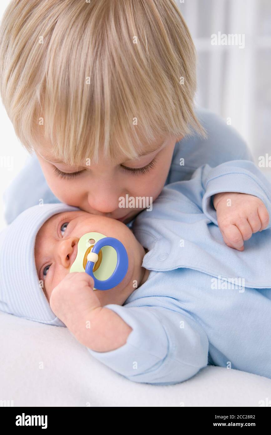 Baby girl (2 months) with boy (4-5 years), portrait Stock Photo